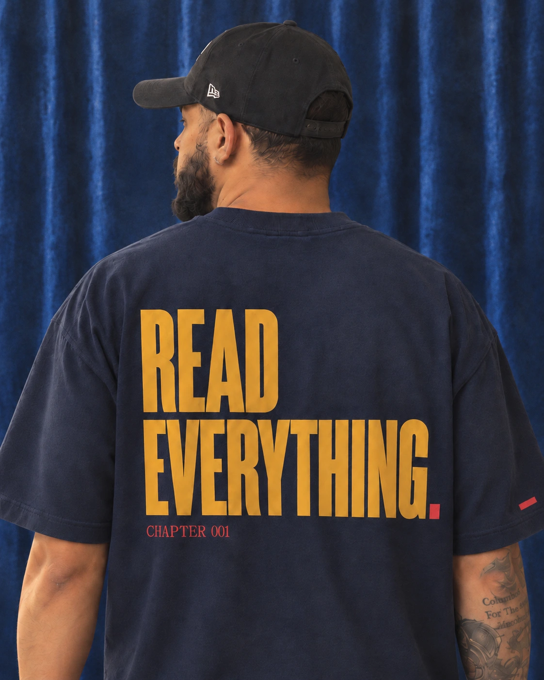 Waist-up back view of Cherokee wearing the Read Everything tee